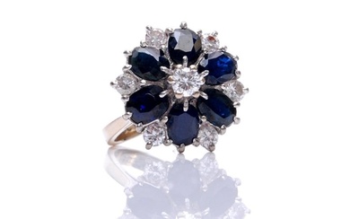 An 18ct white gold sapphire and diamond cluster ring, centra...