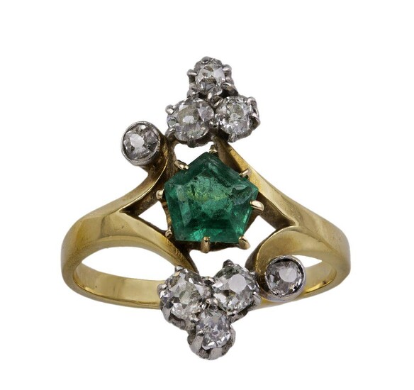 An Edwardian gold, emerald and diamond cluster ring, centring on a pentagonal emerald, set between a pair of old-cut diamond trefoils with additional diamond accents, ring size M 1/2