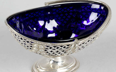 An Edwardian silver pedestal sugar basket with swing handle and blue glass liner.