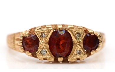 An Edwardian style 9ct gold garnet and diamond three stone r...