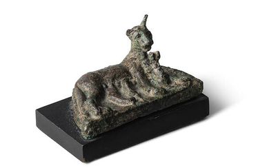 An Egyptian bronze cat with three kittens