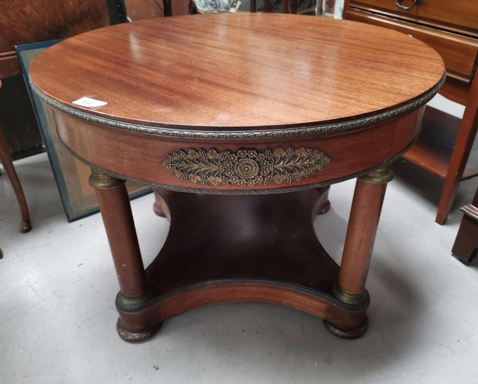 An Empire style mahogany circular coffee table with column l...