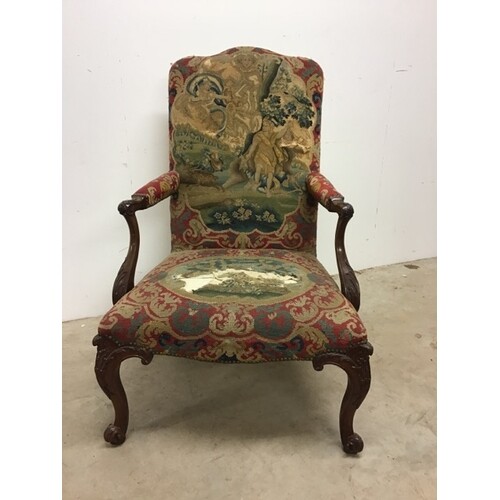 An early 19th century mahogany upholstered armchair on carve...
