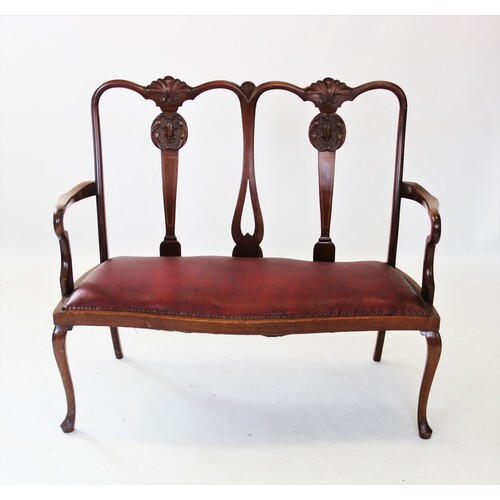 An early 20th century Chippendale revival twin seat mahogany...