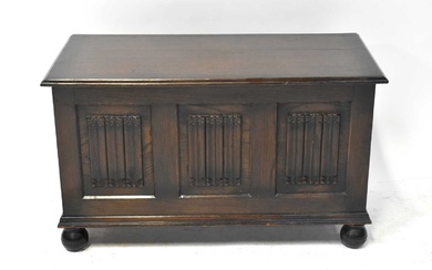 An early 20th century oak cross-banded coffer, decorated with three...