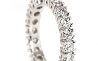 An eternity diamond ring set with numerous brilliant-cut diamonds, mounted in 18k...