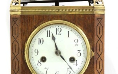 An oak and brass-mounted mantel clock