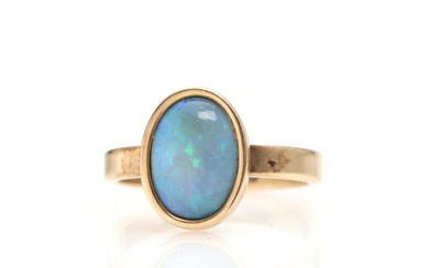 An opal ring set with opal triplet, mounted in 14k gold. Weight...