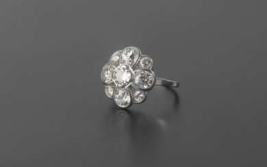 Platinum daisy ring 850 thousandths, set with nine old cut round diamonds.