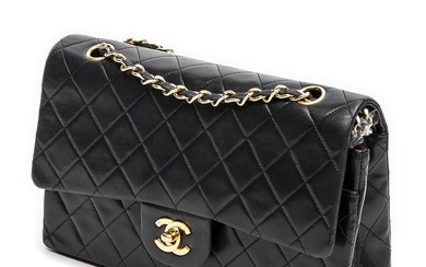 Chanel A “Classic Double Flap” bag of black quilted leather with gold...