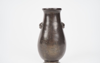 Chine XVIIe-XVIIIe siècle, Vase hu en bronze de patine claire, à décor niellé d'argent, de...