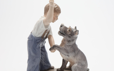 DAHL JENSEN. A PORCELAIN FIGURINE, A BOY WITH A DOG, 20th century.