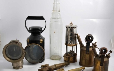 Essolube bottle, Lucas lamp, B.R. (M) lamp, miners lamp, two brass taps, two blow lamps.