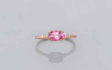 Fine rose gold ring, 750 MM, set with an oval pink sapphire weighing 1.06 carat between two lines of brilliants, size: 53, weight: 1.85gr. gross.