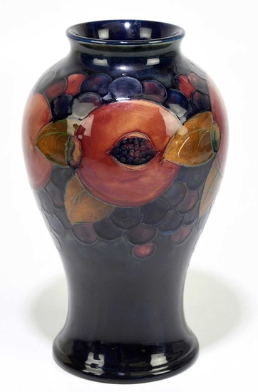 MOORCROFT; a 'Pomegranate' pattern vase, decorated with fruit and berries...