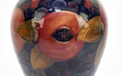 MOORCROFT; a 'Pomegranate' pattern vase, decorated with fruit and berries...
