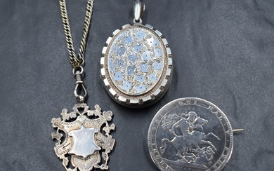 Three pieces of silver and white metal jewellery including a Georgian coin brooch dated 1820, a