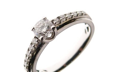 Unmarked white metal and diamond ring, the central brilliant...