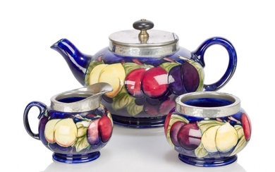 William Moorcroft (1872-1945), a pewter mounted earthenware 'Wisteria' pattern tea...