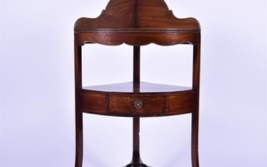 A late Victorian mahogany corner washstand with single drawer over an undertier, on outswept legs, 61 cm x 106 cm.