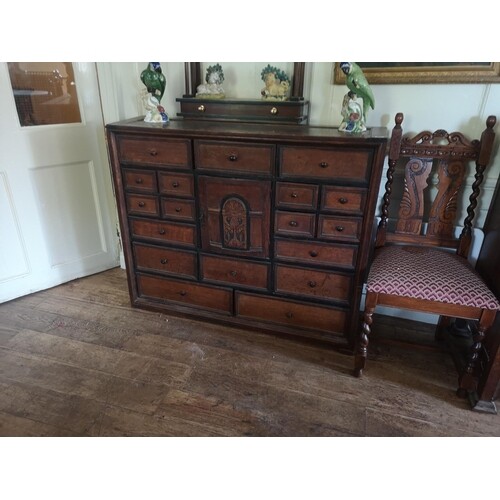 A 19TH CENTURY OAK BANK OF TWENTY-TWO DRAWERS The central f...