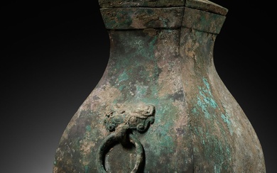 A BRONZE STORAGE VESSEL AND COVER WITH BIRD-FORM FINIALS, FANGHU, HAN DYNASTY