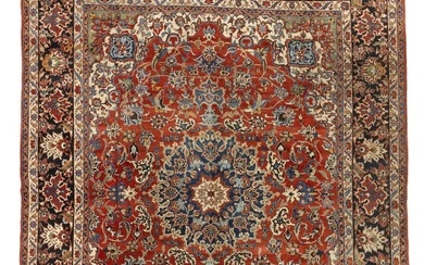 A Baktiari carpet, Persia. Stylized medallion design on a red field of large decorative palmettes, enwtined branches and foliage. 1940–1950. 405×329 cm.