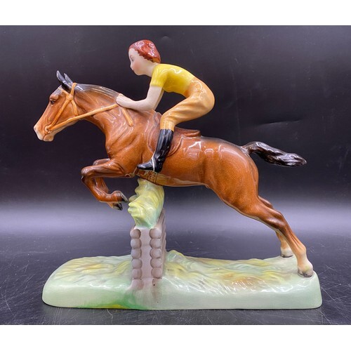 A Beswick figure of a girl on a jumping horse. Approx 25cms ...