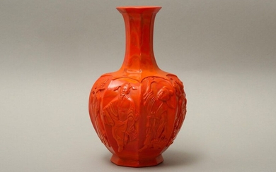 A CHINESE PEKING GLASS RED 'EIGHT IMMORTALS' VASE. Qing Dynasty, 19th Century. The faceted octagonal ovoid body with a tall flared neck raised on a splayed foot, each face of the body decorated in turn with Zhang Guolao holding a tube-shaped bamboo...