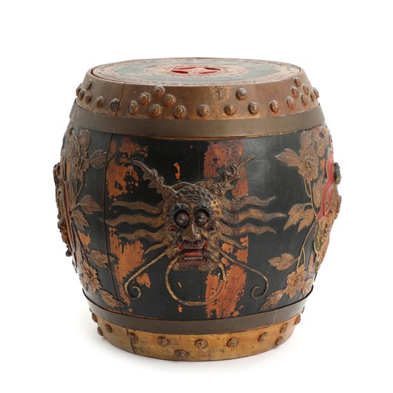 A Chinese barrel shaped paint wood rice container, decorated in relief. C. 1900. H. 39 cm.