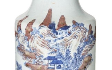 A Chinese porcelain underglaze copper-red and blue cylindrical vase, 18th century, painted with an expansive mountainous landscape with a scholar and attendant crossing a bridge on horseback, a pair of scholars sat in discussion on a rocky outcrop...