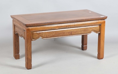 A Chinese rosewood low rectangular table with a shaped frieze and block legs, height 46cm, width 90c
