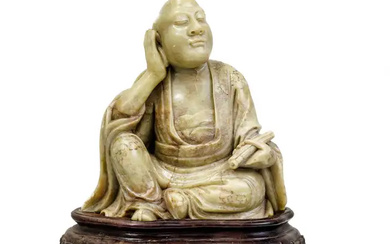 A Chinese soapstone carving of a luohan Qing dynasty The seated figure...