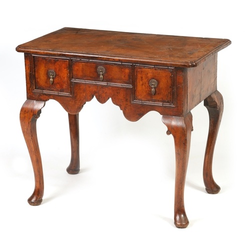 A GEORGE I FIGURED WALNUT AND HERRING-BANDED LOWBOY with ins...