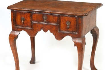 A GEORGE I FIGURED WALNUT AND HERRING-BANDED LOWBOY with ins...