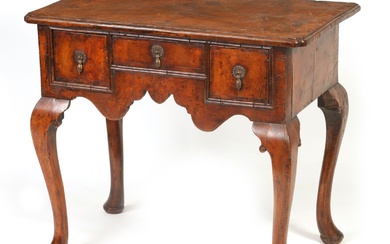 A GEORGE I FIGURED WALNUT AND HERRING-BANDED LOWBOY with...
