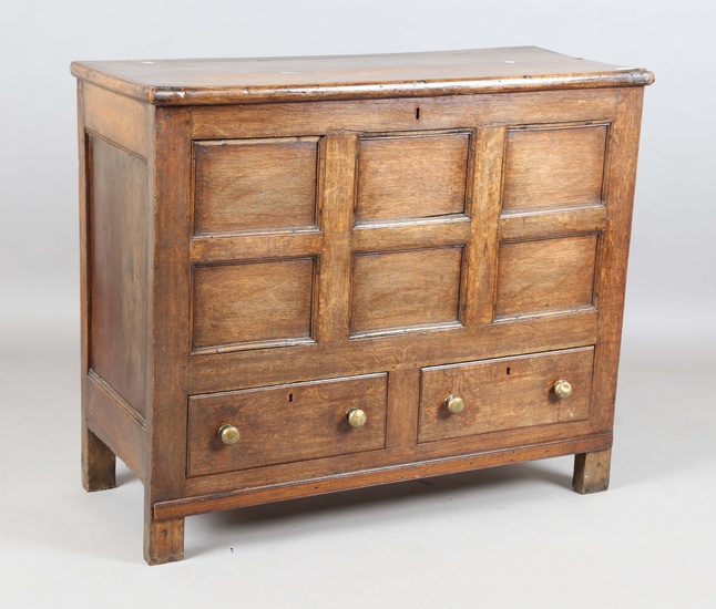 A George III provincial oak mule chest, the removable lid above a panelled front and two drawers, he