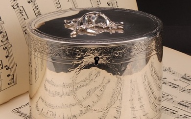 A George III silver oval tea caddy, flush-hinged cover with ...