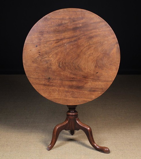 A Georgian Mahogany Tilt-topped Tripod Table (A/F). The single piece flame figured top supported by