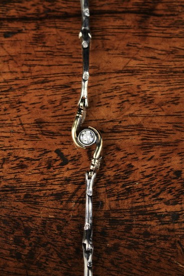 A Jessica McCormack Silver & Diamond Bracelet. The bracelet designed as a chain of bones studded wit
