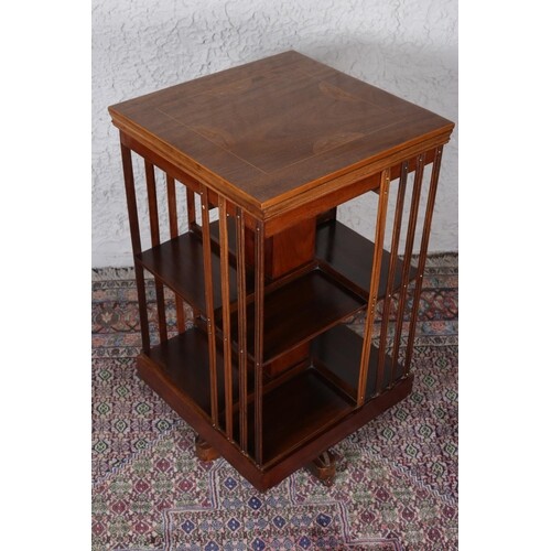 A MAHOGANY AND MARQUETRY INLAID REVOLVING BOOKSTAND the squa...