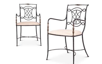 A PAIR OF FRENCH BRASS MOUNTED IRON OPEN ARM CHAIRS IN THE MANNER OF GILBERT POILLERAT (B.1902-1988)