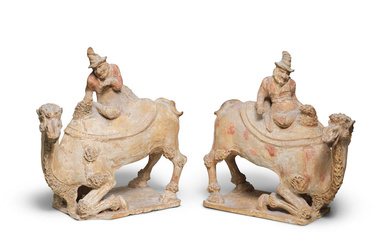 A PAIR OF PAINTED POTTERY MODELS OF CAMELS AND FOREIGN...