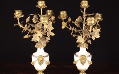 A Pair of Louis XVI Style White Marble & Gilt Metal Five Light Candelabra. The candle cups nestled i