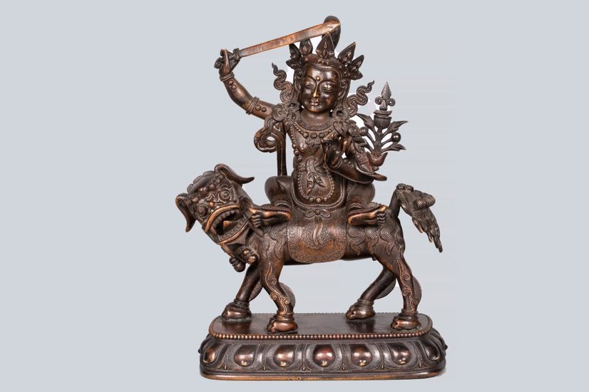 A Patinated Bronze Figure of Manjushri riding a Dragon, China, 18th Century.