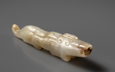 A RARE WHITE AND RUSSET JADE 'TIGER' PENDANT, SHANG DYNASTY