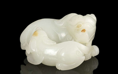 A RUSSET AND WHITE JADE ‘DOG AND CUB’...