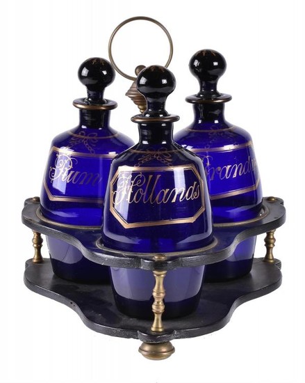 A Regency papier mâché tripartite decanter stand and three blue glass barrel-shaped decanters and stoppers