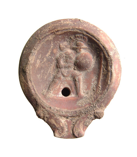 A Roman discus oil lamp depicting a gladiator