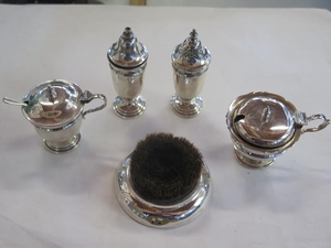 A Silver cruet set with two glass liners, salt spoon, overal...